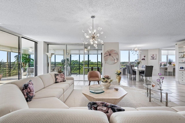 living room featuring light tile patterned flooring, a textured ceiling, and a notable chandelier