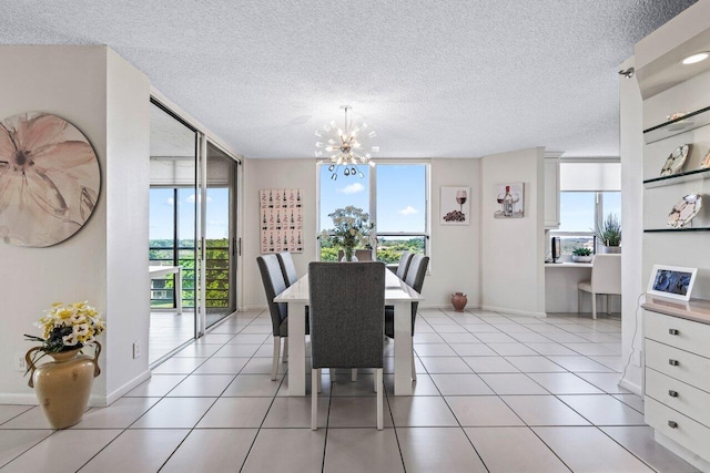 tiled dining area featuring a textured ceiling, a chandelier, and a healthy amount of sunlight