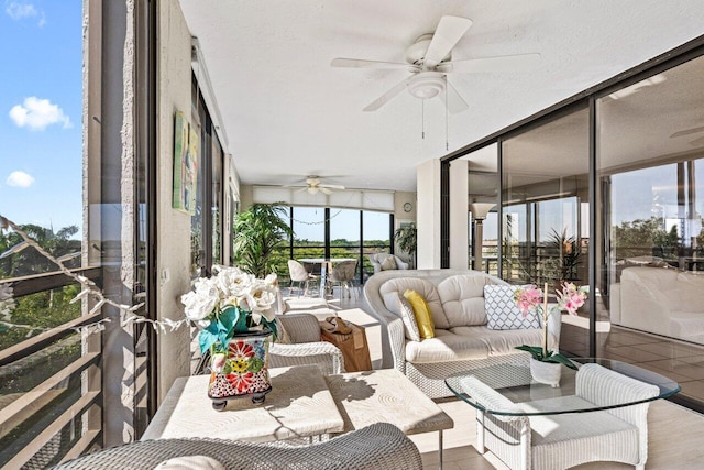 sunroom / solarium featuring ceiling fan