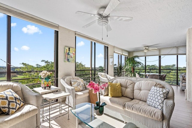 sunroom featuring ceiling fan