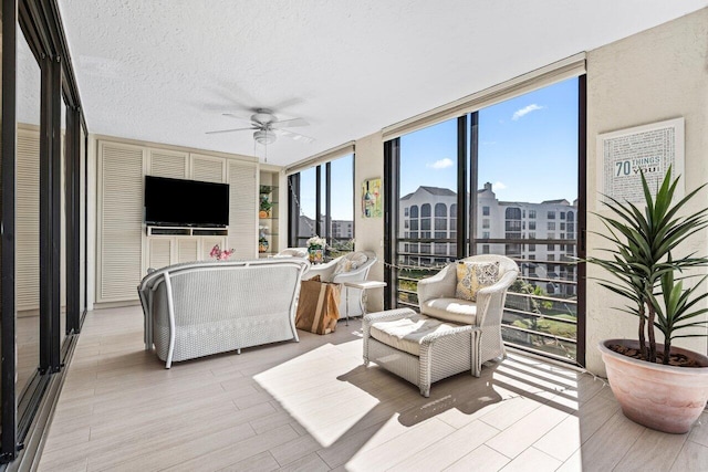 sunroom / solarium with plenty of natural light and ceiling fan