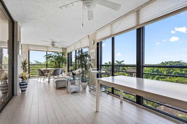 sunroom featuring ceiling fan