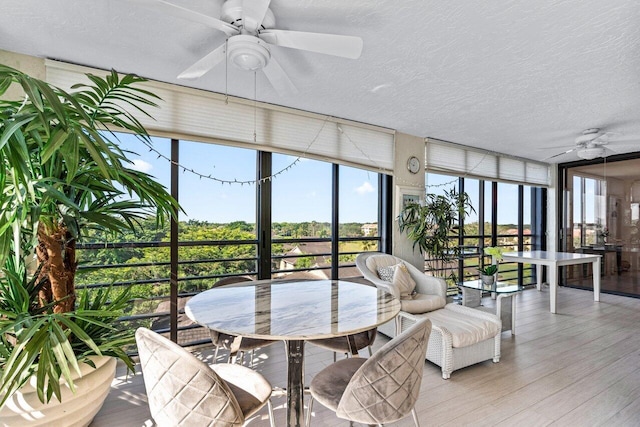 sunroom / solarium featuring ceiling fan