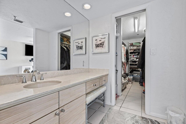 bathroom featuring vanity, tile patterned flooring, and a textured ceiling