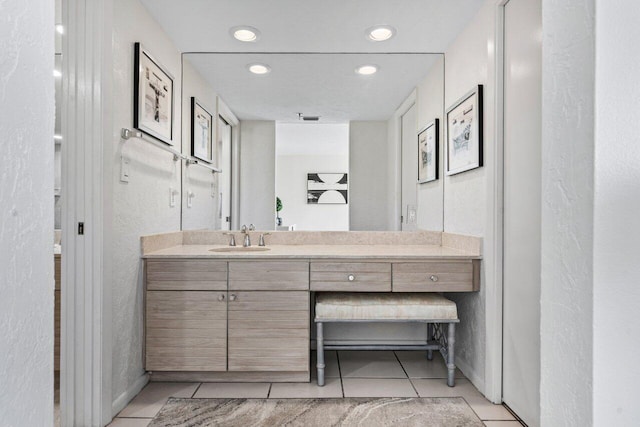 bathroom with tile patterned flooring and vanity