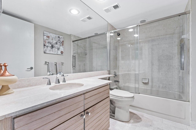 full bathroom with vanity, tile patterned flooring, enclosed tub / shower combo, and toilet