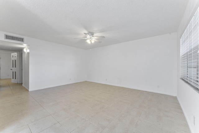 spare room with a textured ceiling and ceiling fan