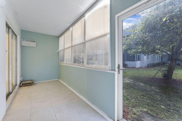 unfurnished sunroom with a wall unit AC