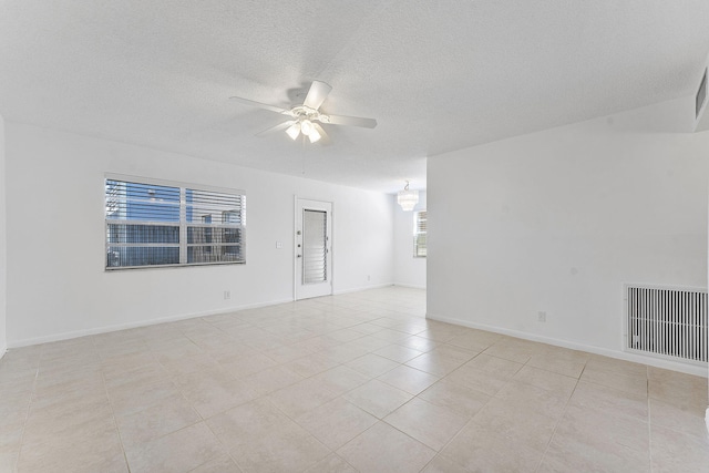 spare room with light tile patterned flooring and ceiling fan