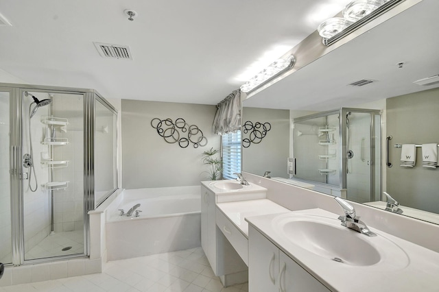 bathroom featuring independent shower and bath, vanity, and tile patterned flooring