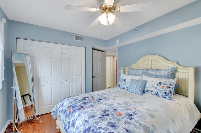 bedroom featuring hardwood / wood-style floors, a closet, and ceiling fan