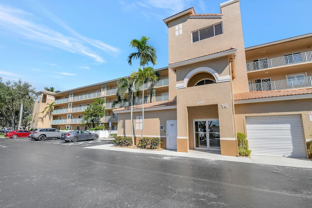 12560 Majesty Cir Unit 401, Boynton Beach, FL 33437 - view of apartment building / complex with uncovered parking
