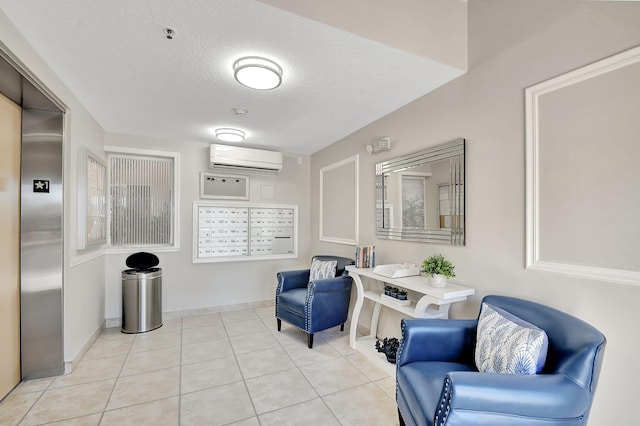 sitting room with a mail area, a textured ceiling, light tile patterned floors, an AC wall unit, and elevator