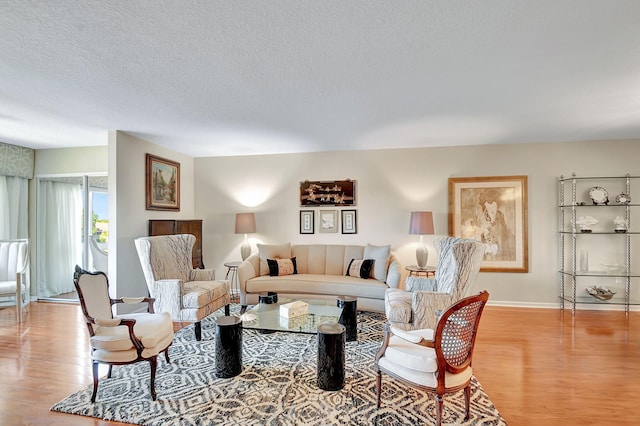 living room featuring light hardwood / wood-style floors and a textured ceiling