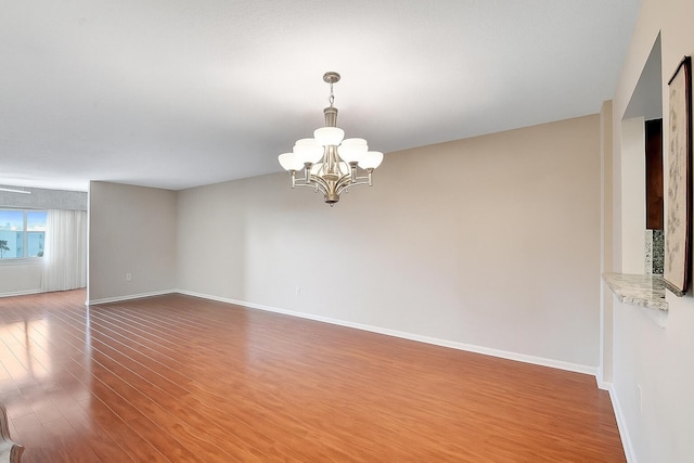 12560 Majesty Cir Unit 401, Boynton Beach, FL 33437 - unfurnished room featuring a chandelier and wood finished floors