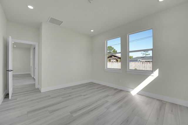 empty room with light hardwood / wood-style flooring