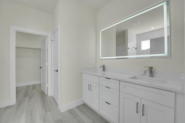 bathroom with vanity, hardwood / wood-style floors, and a shower