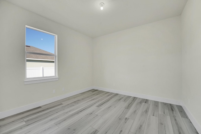 empty room with light hardwood / wood-style flooring