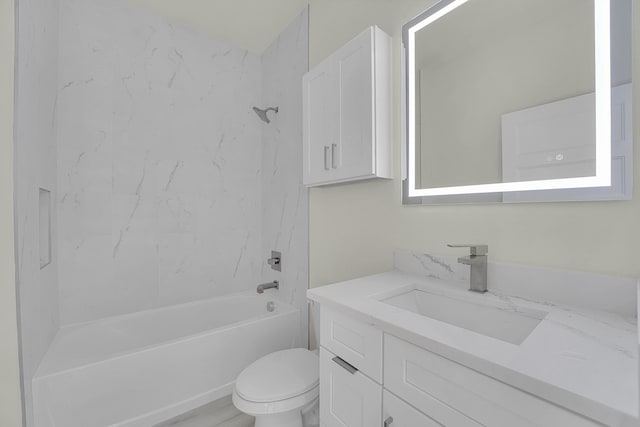 full bathroom featuring tiled shower / bath combo, vanity, hardwood / wood-style flooring, and toilet