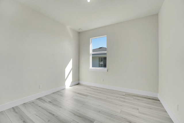 empty room with light hardwood / wood-style flooring