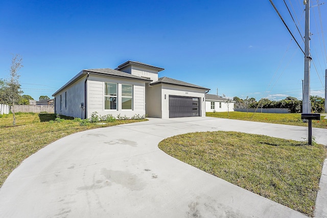 view of front of property with a garage and a front yard