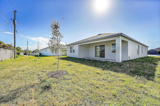 rear view of house with a yard