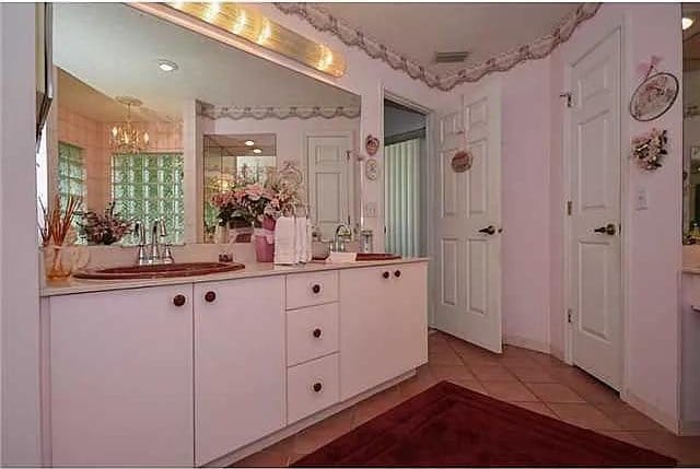 bathroom featuring vanity, a notable chandelier, and tile patterned floors