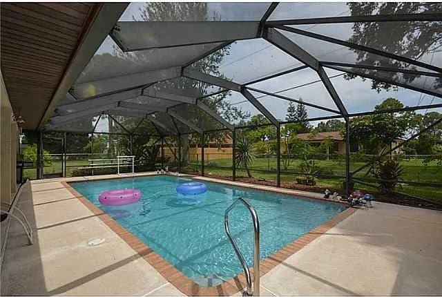 view of pool with a lanai and a patio