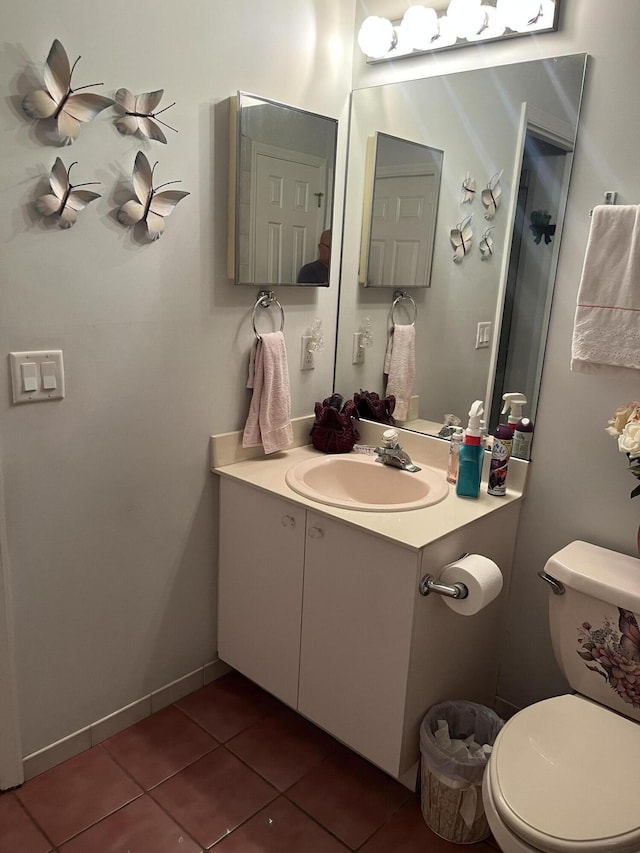 bathroom with vanity, toilet, and tile patterned flooring