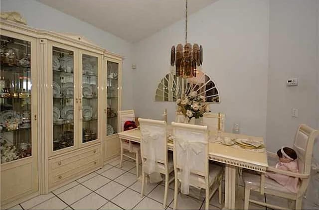 tiled dining area with a chandelier