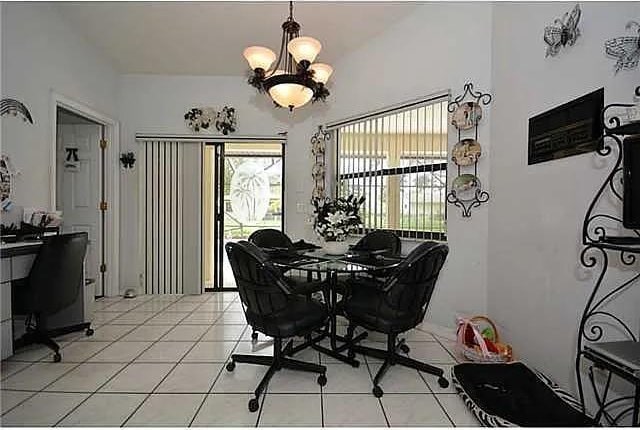 dining room featuring a chandelier and light tile patterned floors