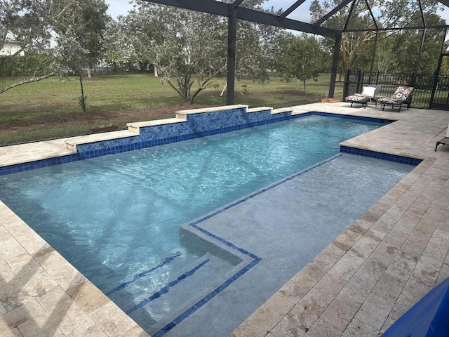 view of swimming pool with a yard, a lanai, and a patio