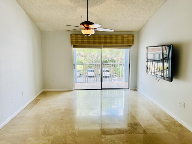 empty room featuring a textured ceiling and ceiling fan