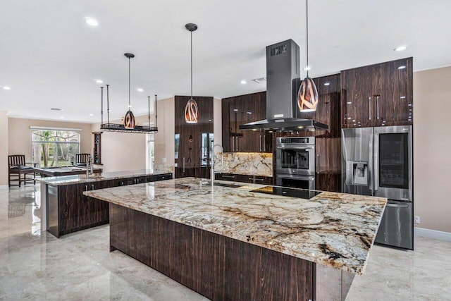 kitchen with pendant lighting, sink, island exhaust hood, stainless steel appliances, and a spacious island