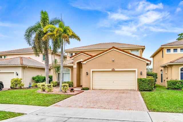 mediterranean / spanish-style house with a garage and a front yard