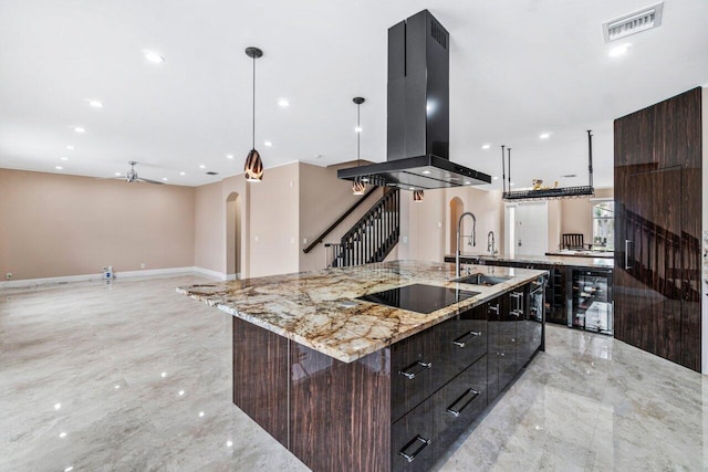 kitchen with a spacious island, dark brown cabinets, pendant lighting, island exhaust hood, and black electric stovetop