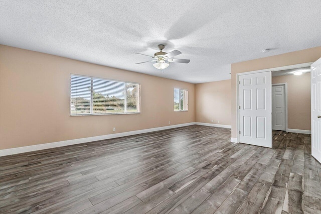 spare room with wood-type flooring, a textured ceiling, and ceiling fan