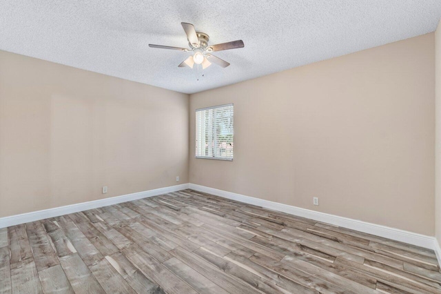 unfurnished room featuring ceiling fan, a textured ceiling, and light wood-type flooring