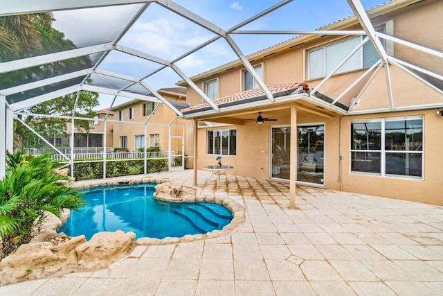 back of house with ceiling fan, glass enclosure, and a patio area