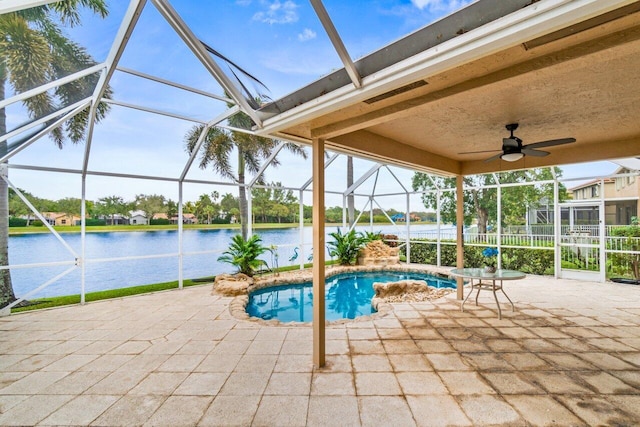 view of pool featuring a lanai, a patio area, ceiling fan, and a water view