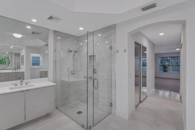 bathroom with vanity, tile patterned flooring, and a shower with door