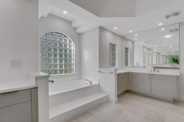 bathroom with vanity and a bath