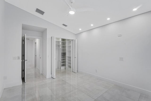 empty room featuring vaulted ceiling and ceiling fan