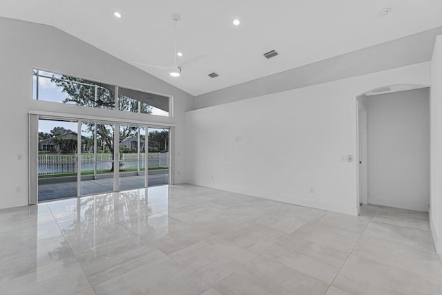 empty room with high vaulted ceiling and ceiling fan