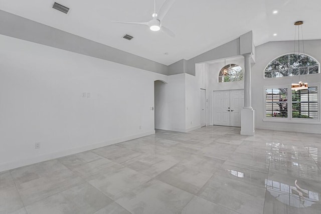 unfurnished living room with high vaulted ceiling and ceiling fan