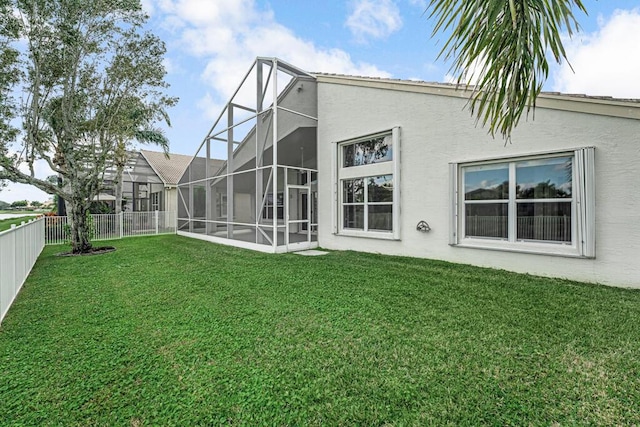 back of house with a lawn