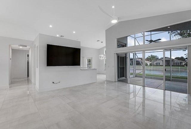 unfurnished living room featuring high vaulted ceiling and ceiling fan