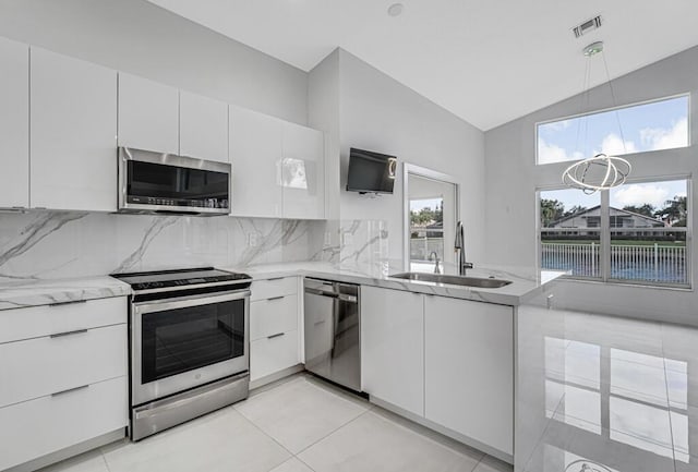 kitchen featuring white cabinetry, sink, backsplash, and appliances with stainless steel finishes