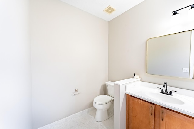 bathroom featuring visible vents, vanity, and toilet