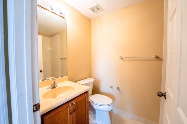 bathroom featuring toilet, baseboards, visible vents, tile patterned flooring, and vanity